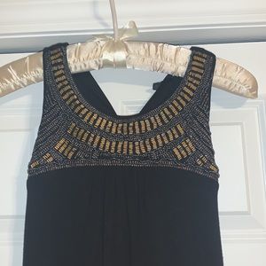 Midi black dress with gold and blue beading by the collar.